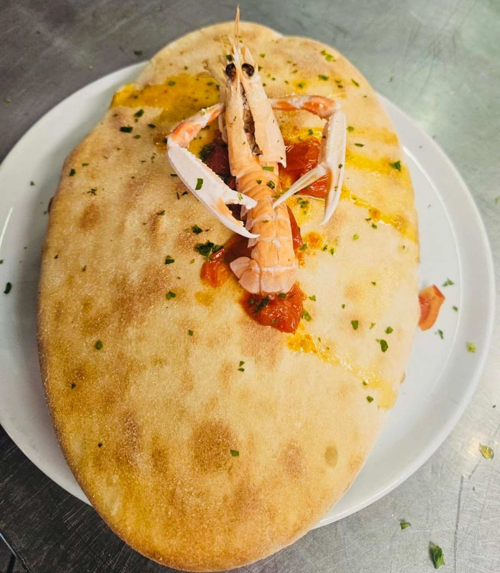 Focaccia gourmet guarnita con scampo e salsa di pomodoro